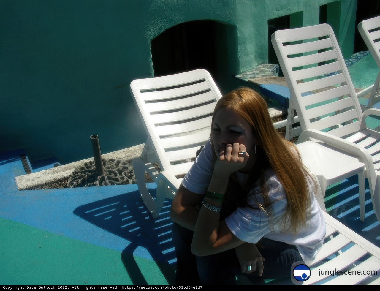 Portrait of a Teen Girl Sitting in Front of a Blue Building