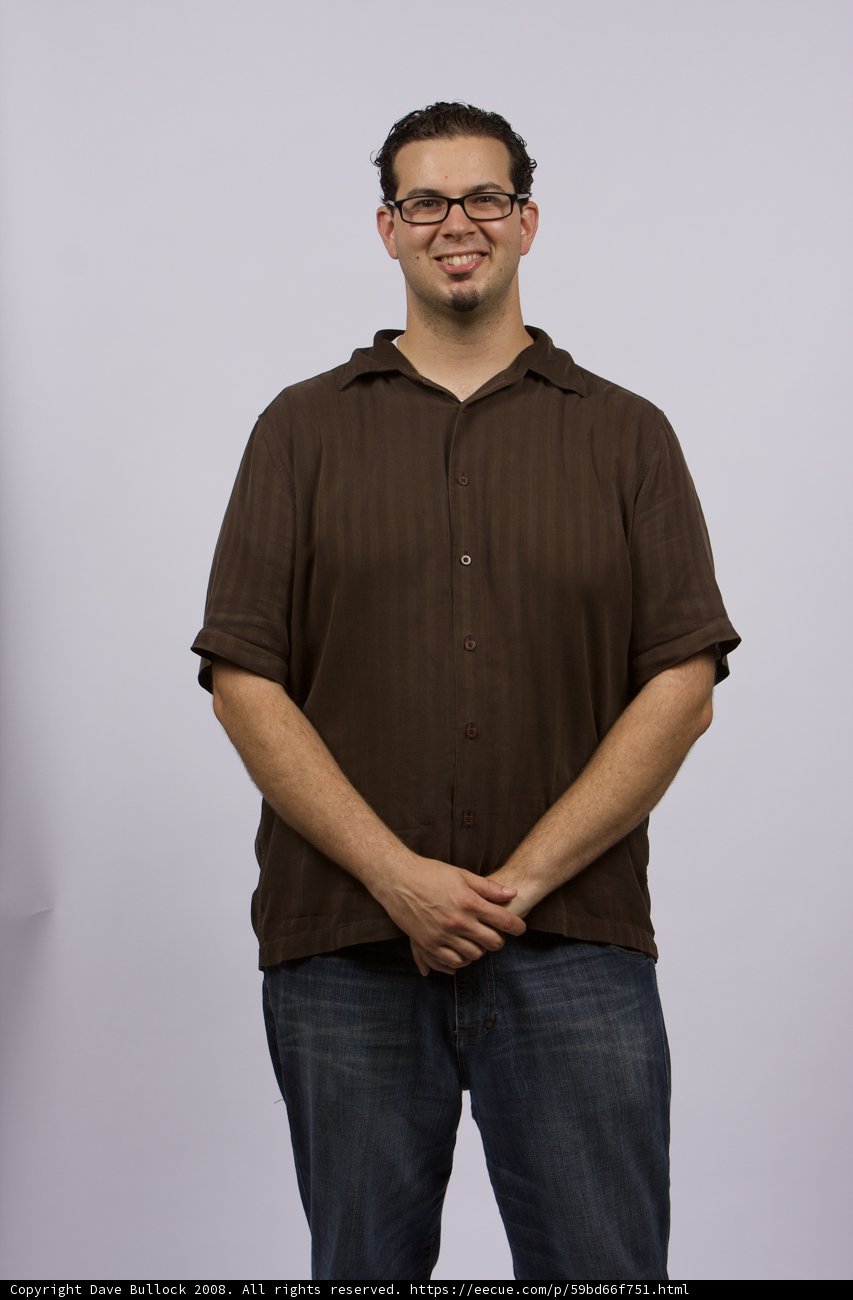 Grinning Guy in Brown Shirt and Glasses