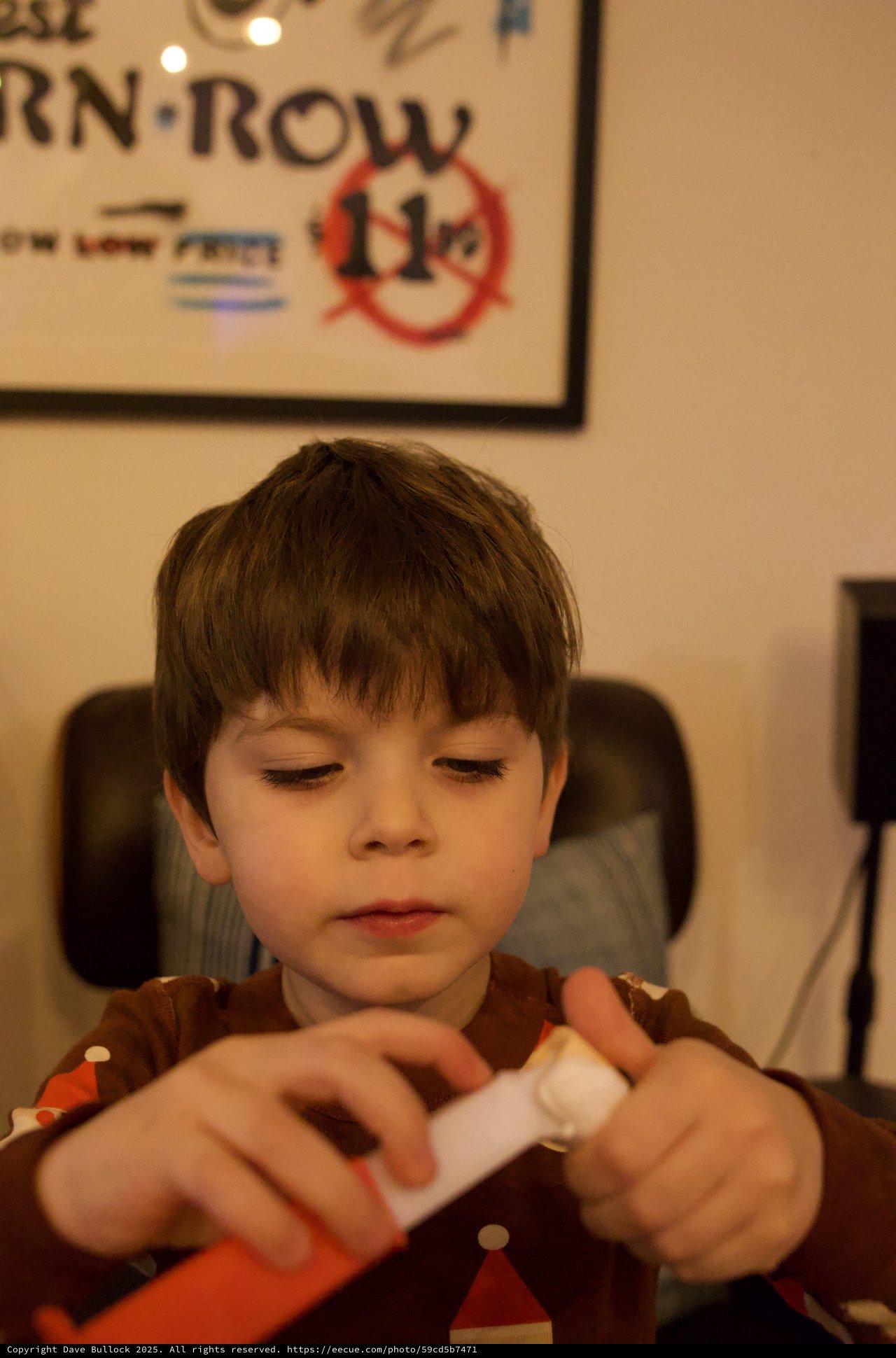 Young Boy Opening Gift on Christmas Evening