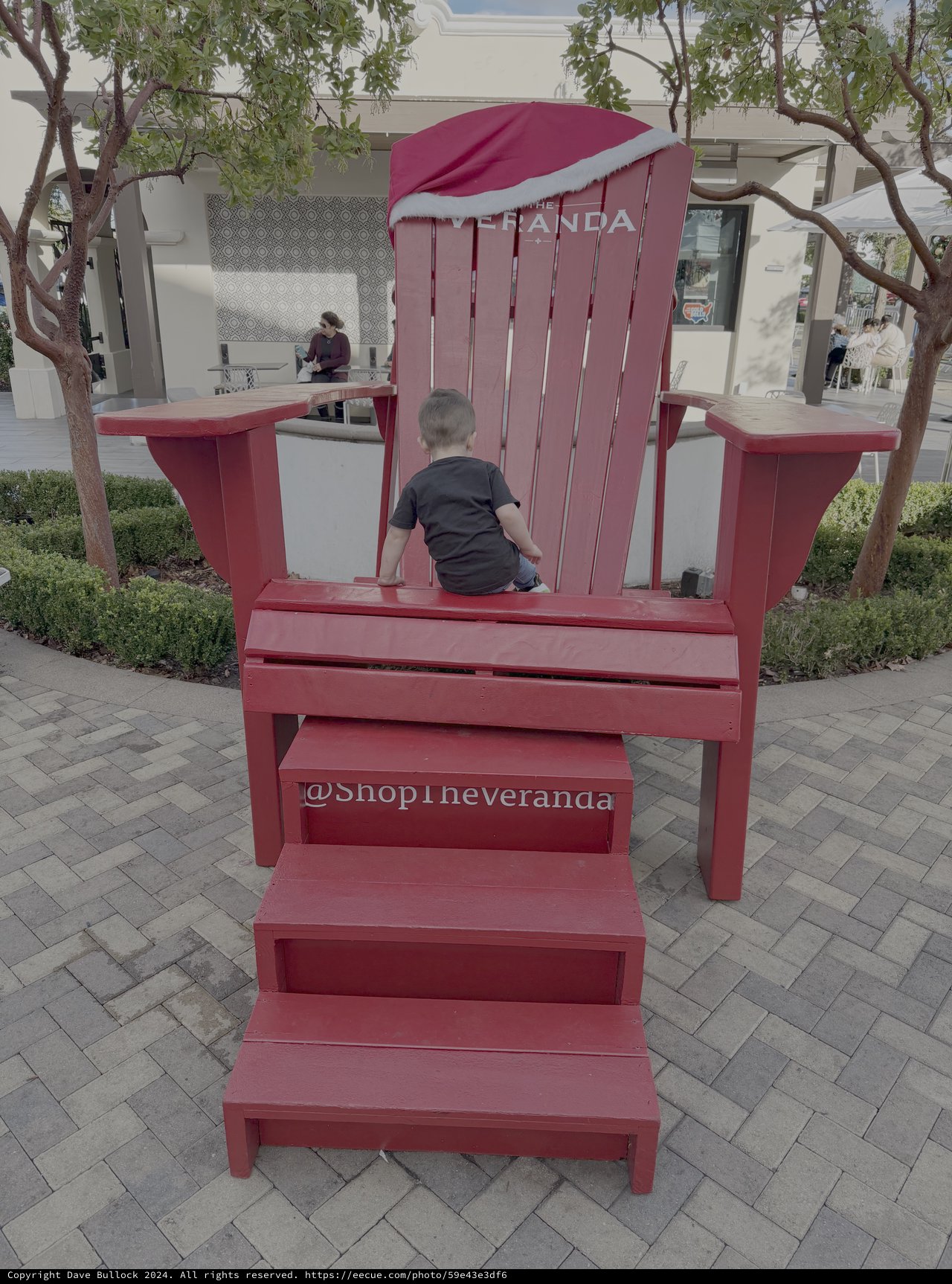 Child Playing on Giant Red Adirondack Chair