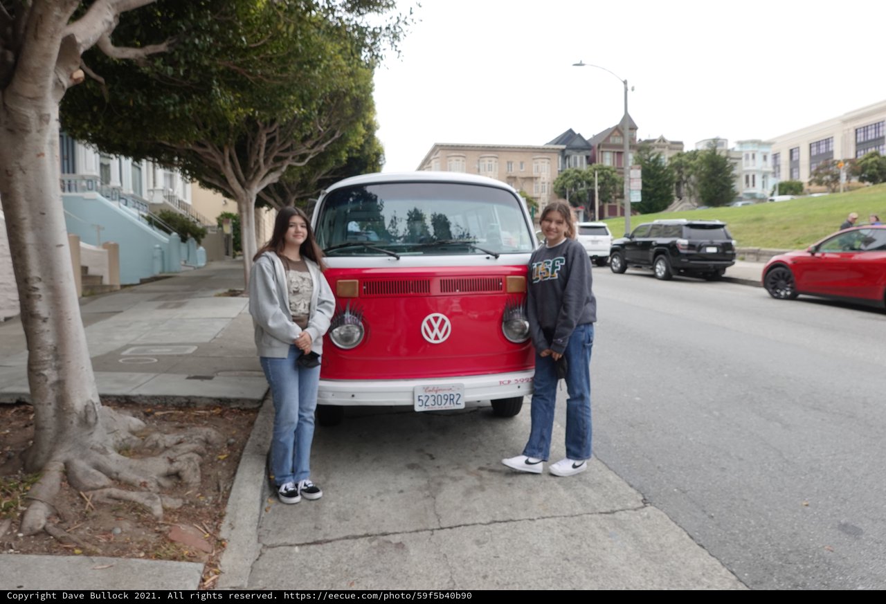 Two Friends Posing with Classic Volkswagen Bus
