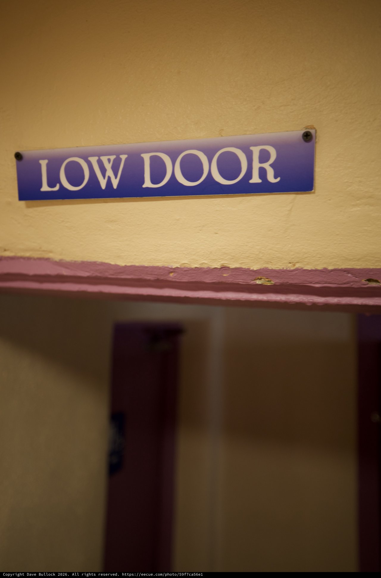 Low Door Sign in Historic Building