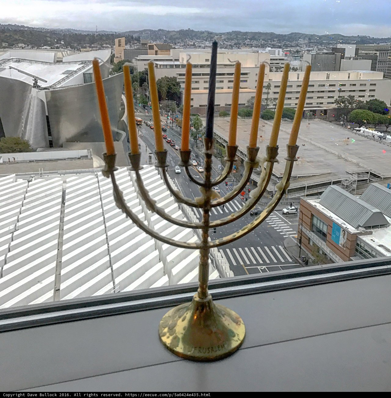 Radiant Hanukkah Menorah shines bright against the cloudy sky