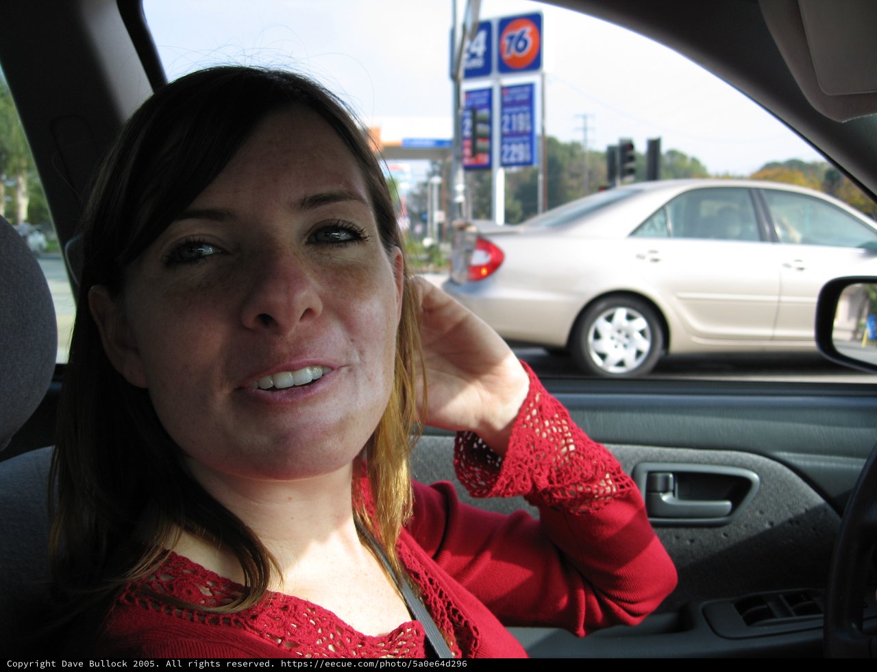 Woman in Red Smiling from Car Passenger Seat