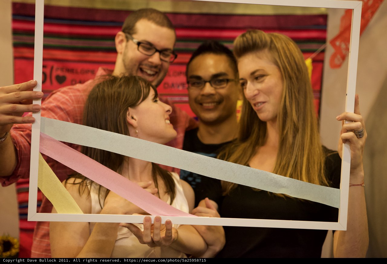 Friends Posing Through a Festive Photo Frame