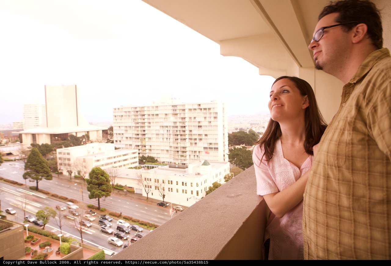 Couple Enjoying City Views from Hotel Balcony
