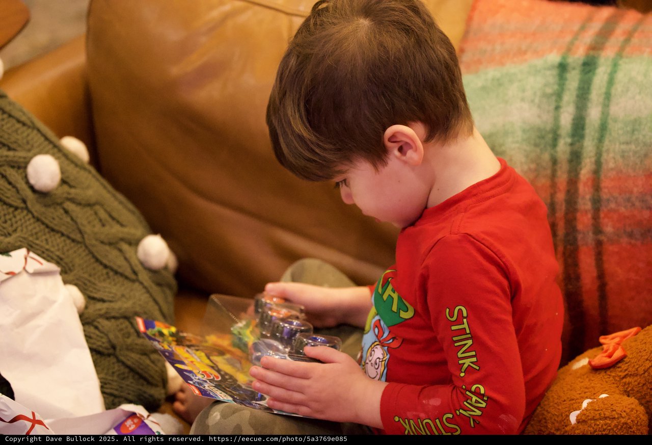 Young Boy Opening Toy on Christmas Morning
