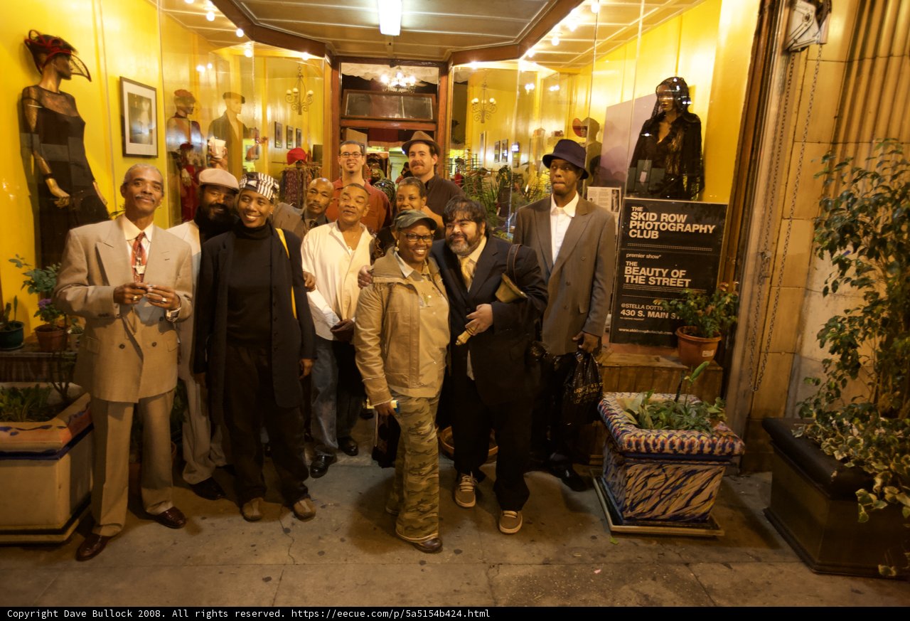 Group Standing in Front of Decorative Plant