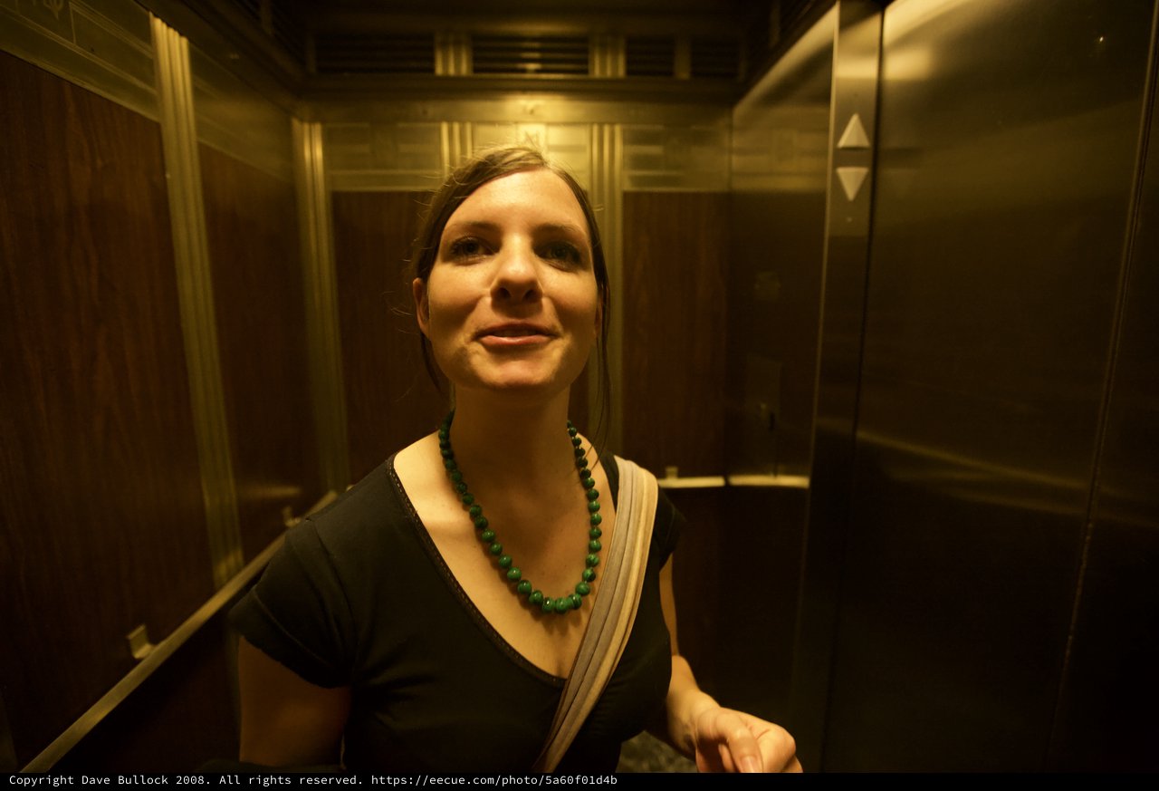Smiling Woman in a Warm Golden Elevator