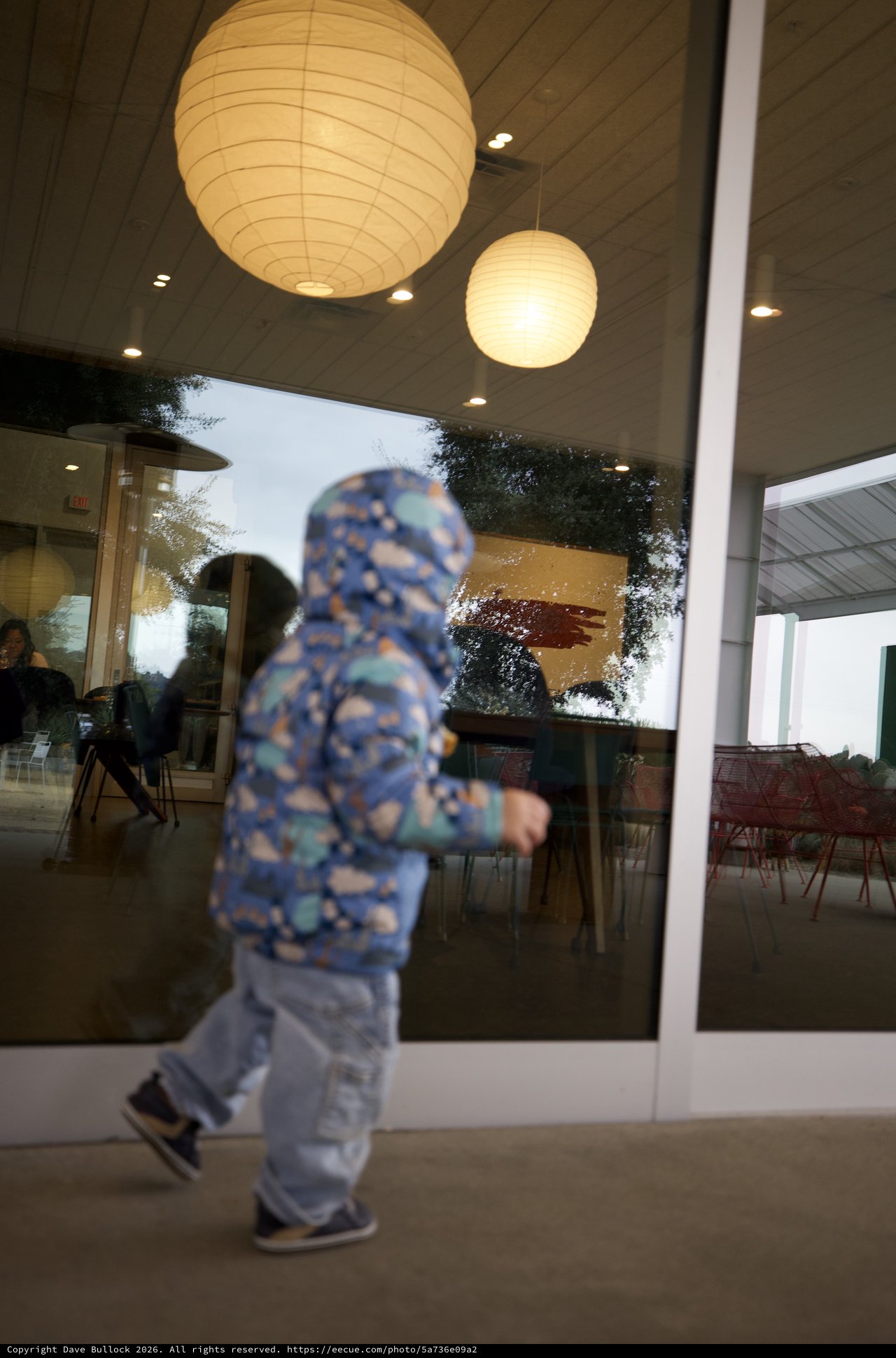 Child in Motion Outside Modern Restaurant