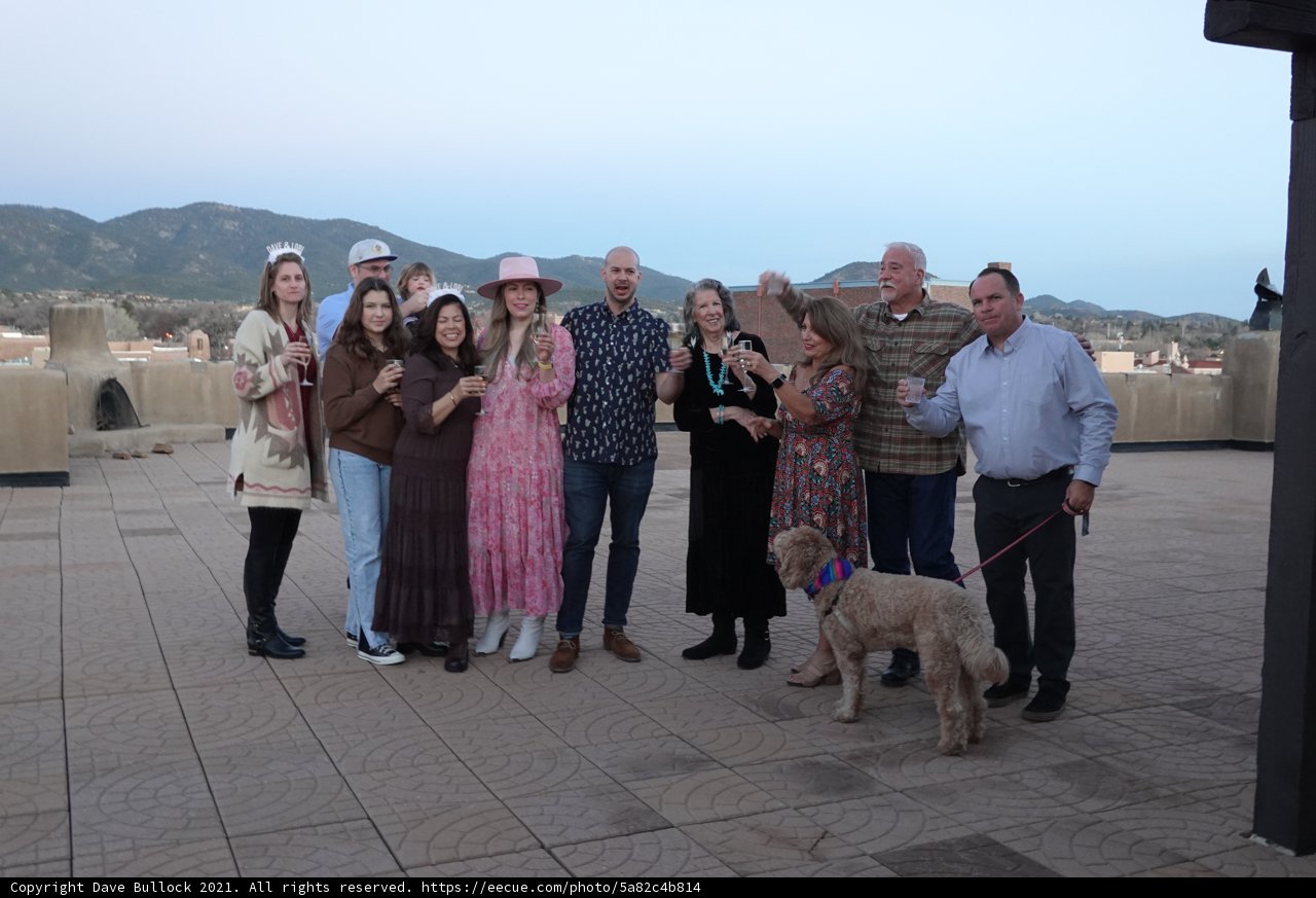 Group of Friends Strike a Pose with a Playful Poodle