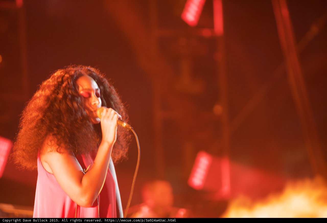 Solange Profile Eyes Closed Singing Scaffolding Red Orange