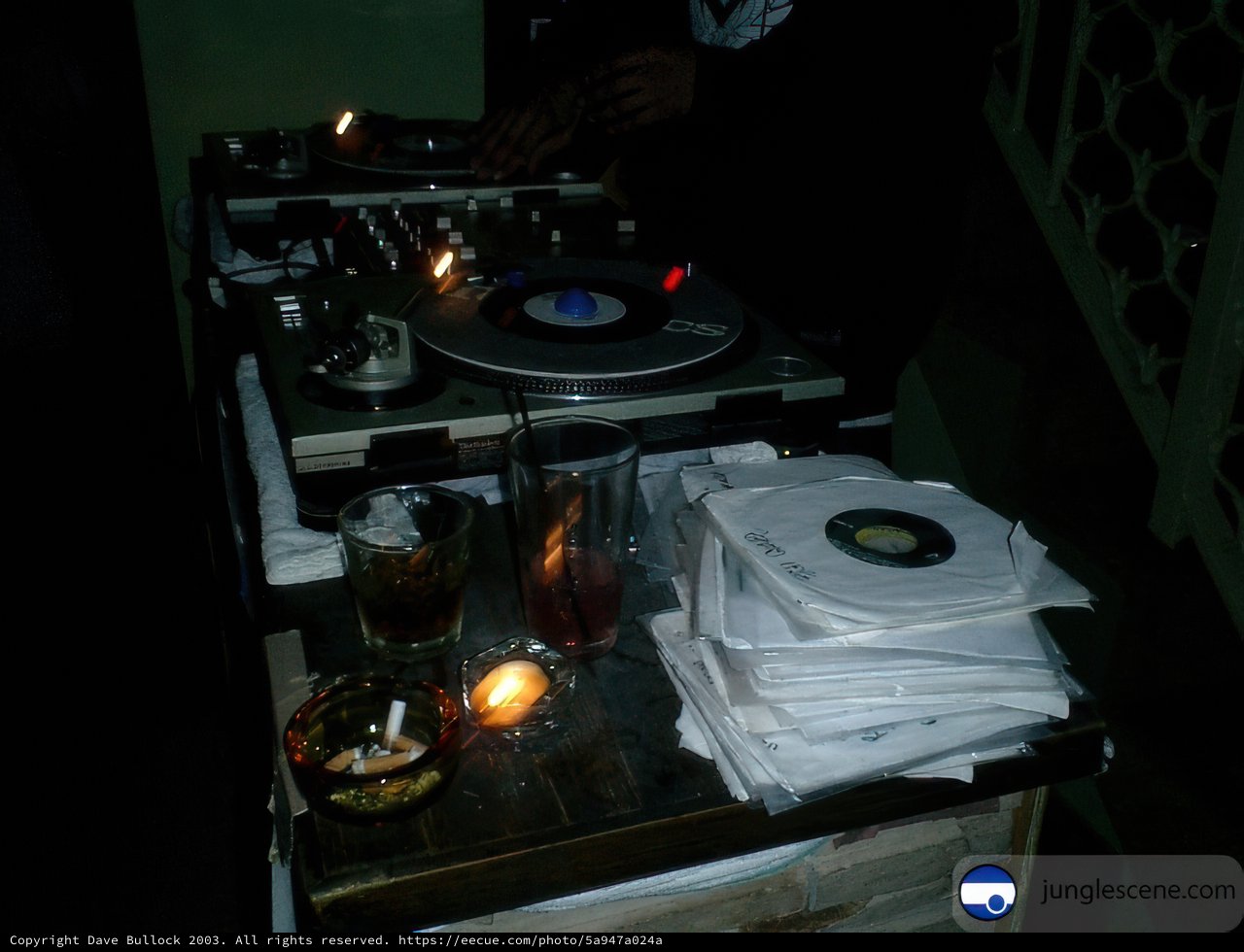DJ spinning records by candlelight