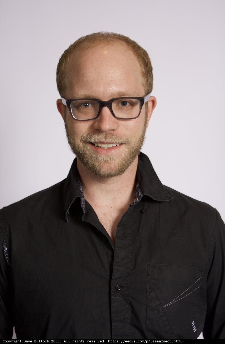 Smiling Man in Black Glasses