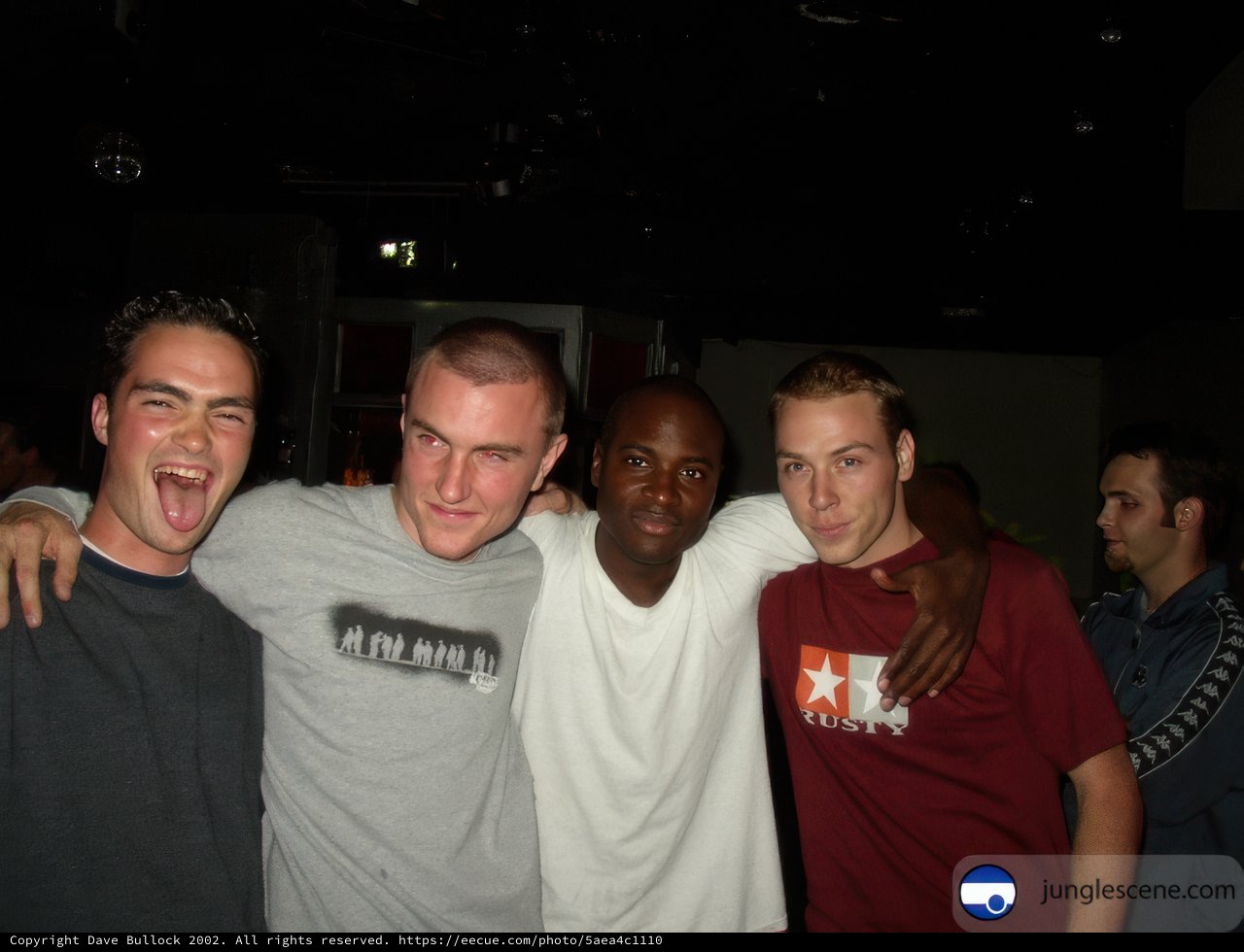Three Young Men Strike a Pose at a Party