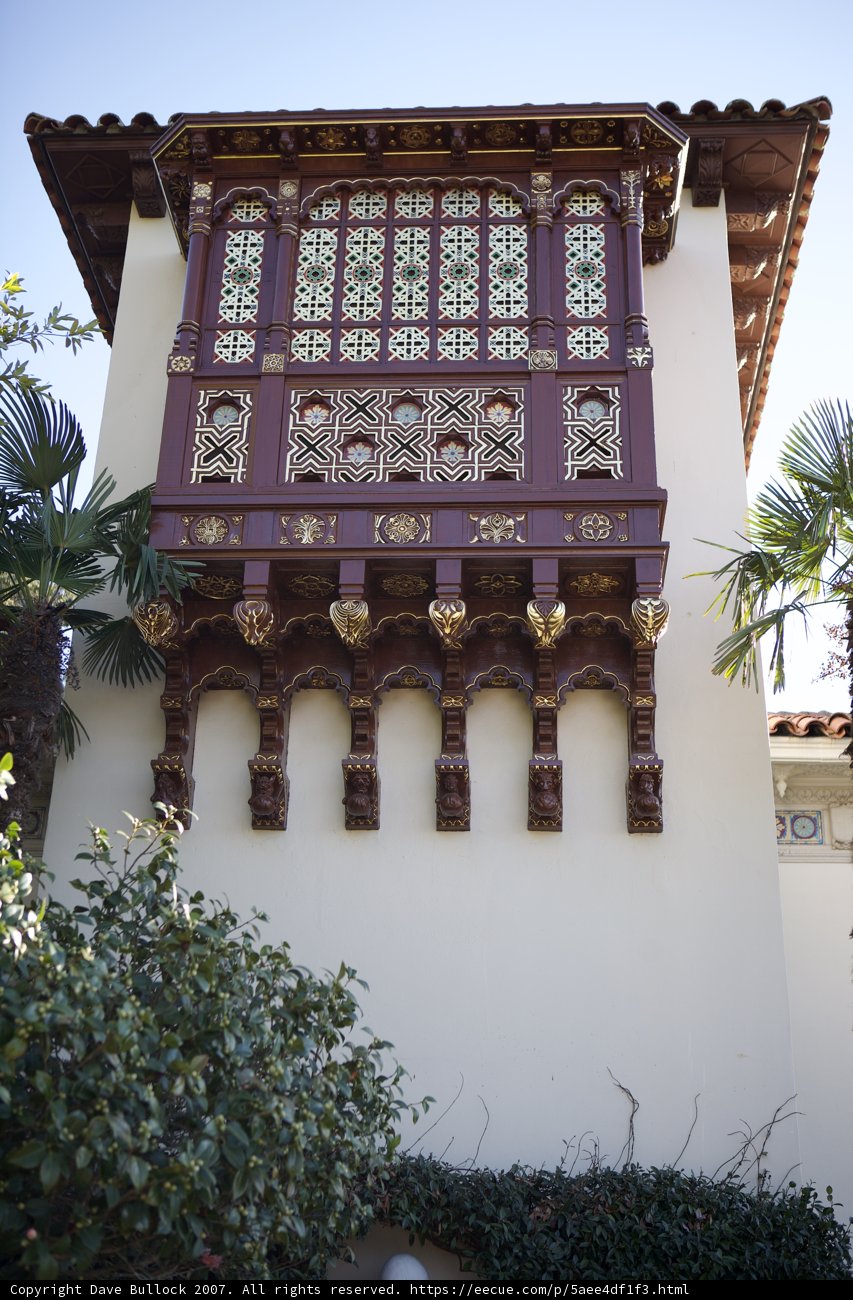 Ornate Monastery Building with Palm Trees and Blue Sky