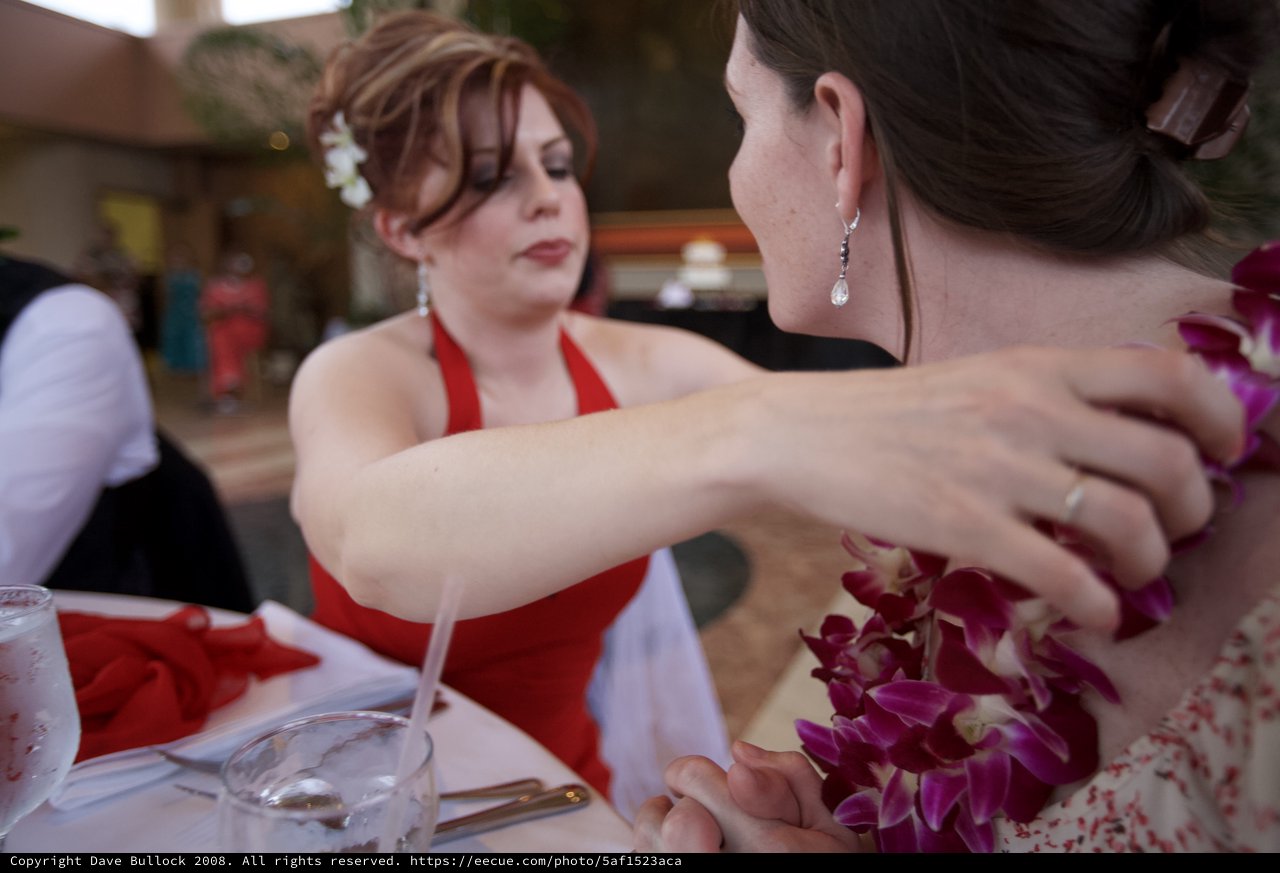 Bridesmaid Adjusts Floral Lei at Hawaiian Wedding Reception