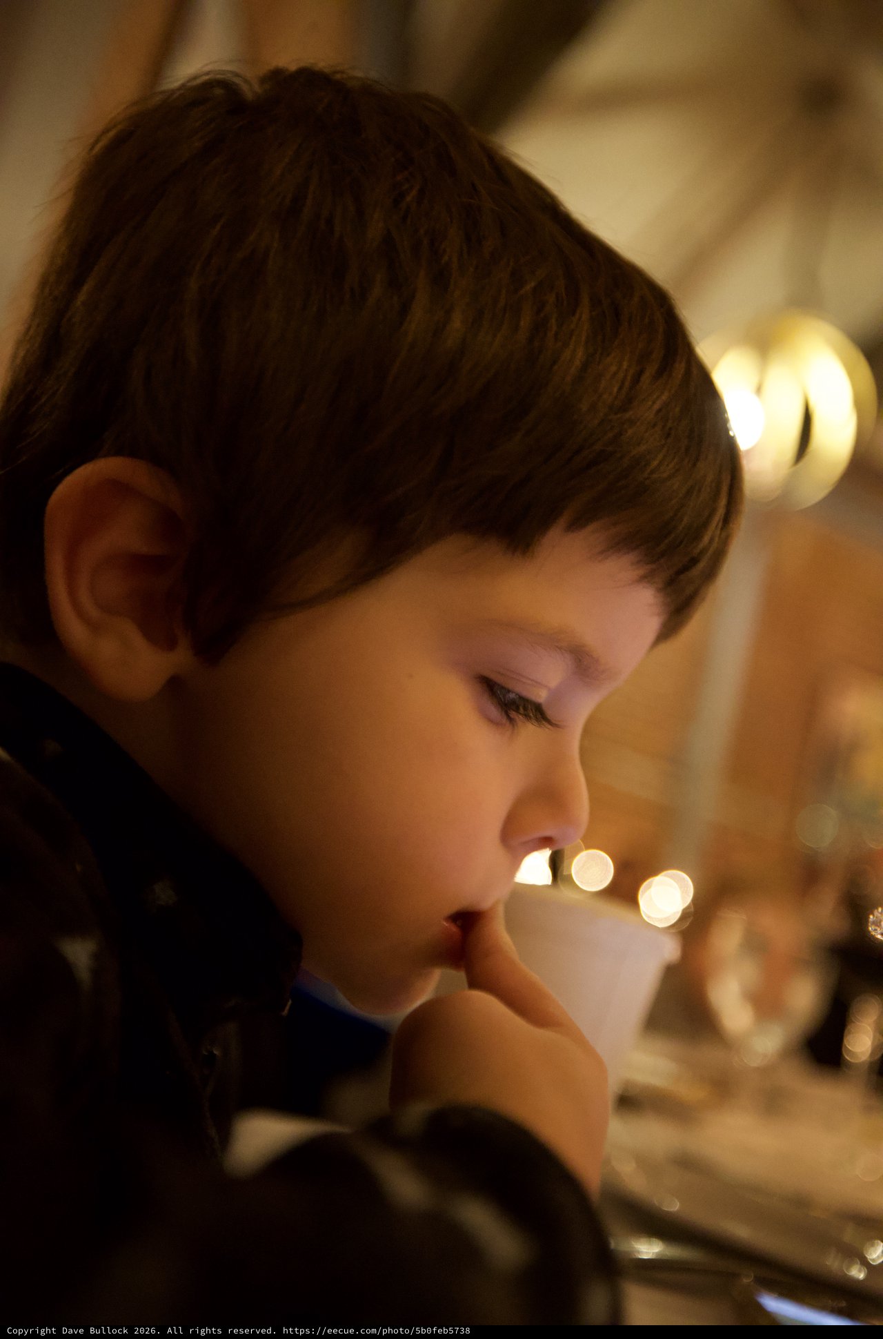 Young Boy Lost in Thoughtful Contemplation by Candlelight