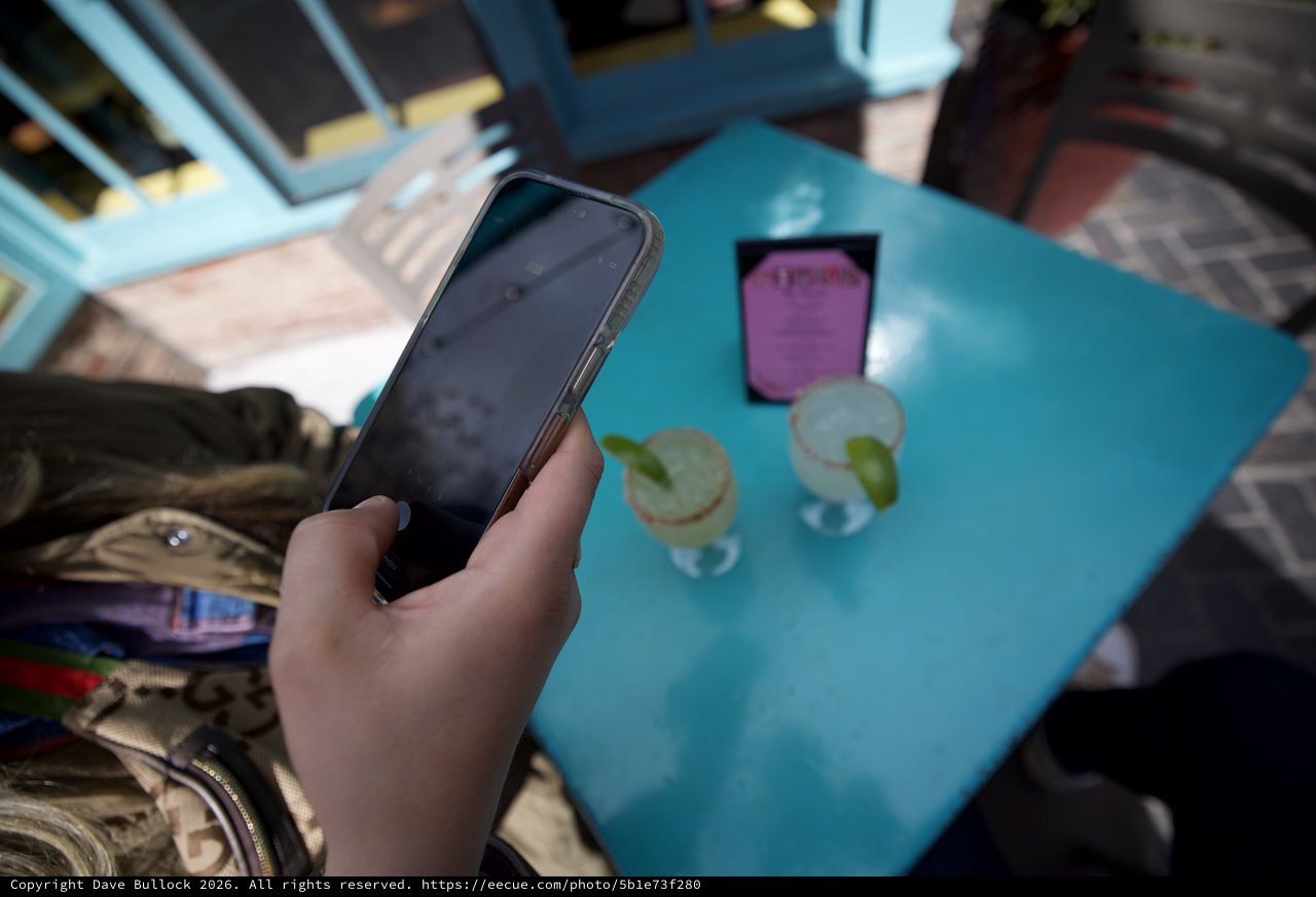 Phone Check at Outdoor Cafe Table