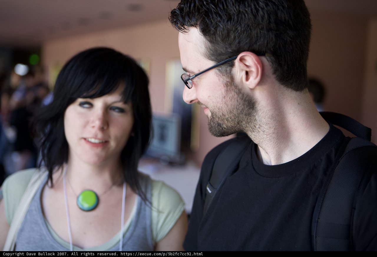 An Eyeglass-Wearing Couple Engage in Conversation
