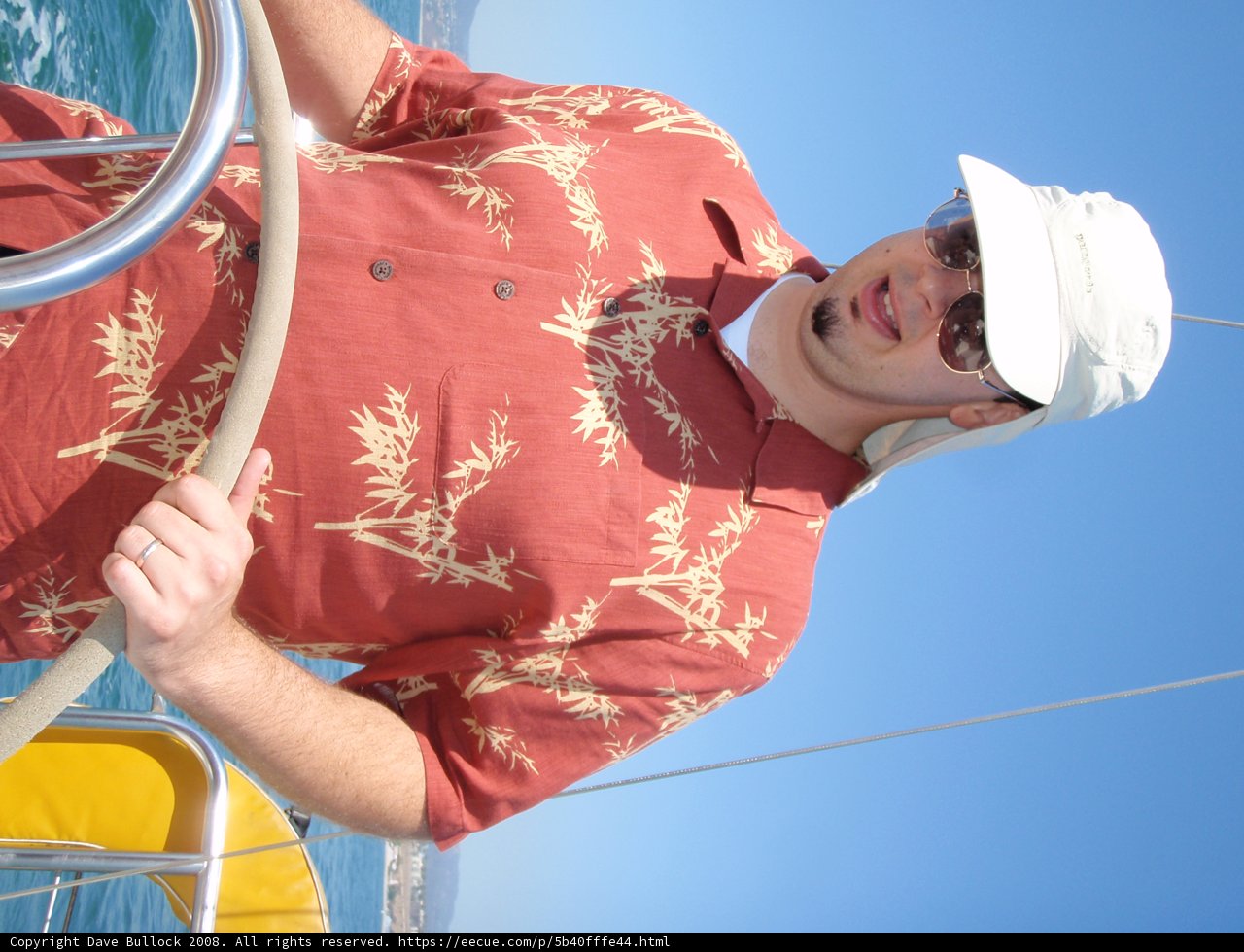 Sailor Style: Man Wearing a Blue Hat on the Open Sea
