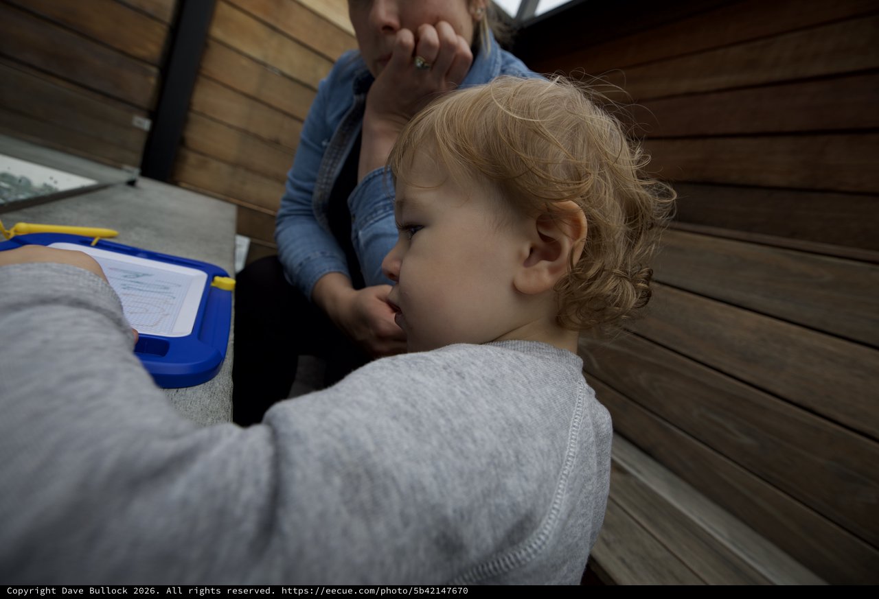 Tender Moment Between Parent and Child on Wooden Deck