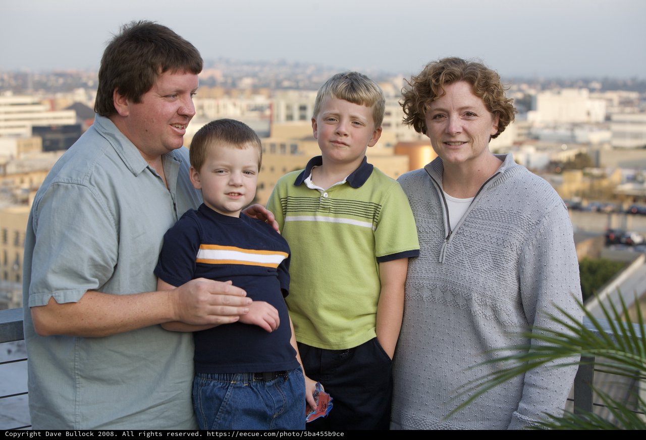 Family Portrait on Rooftop Overlooking City Skyline
