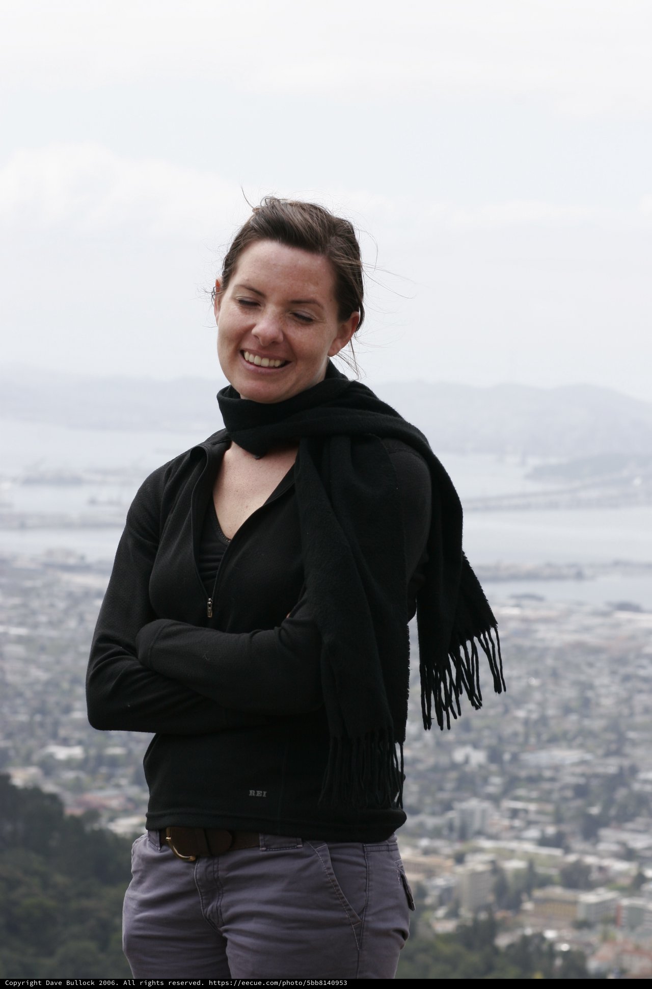 Woman Smiling Atop Hill Overlooking San Francisco Bay