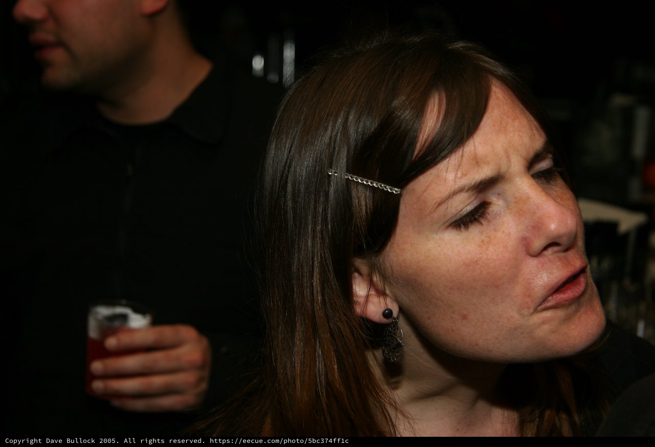 Contemplative Woman at a Dimly Lit Party