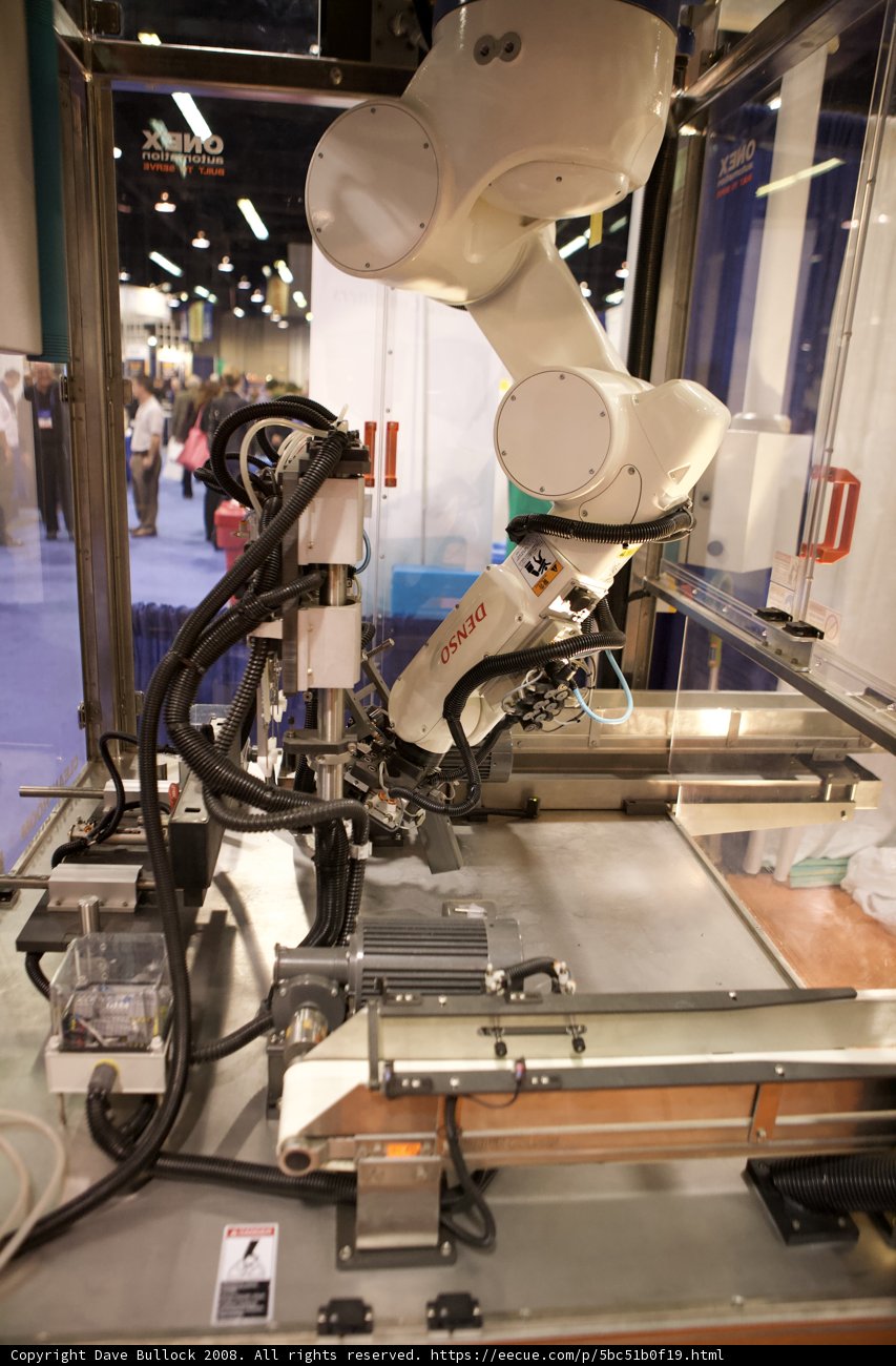 Robot Working on Machine in Factory
