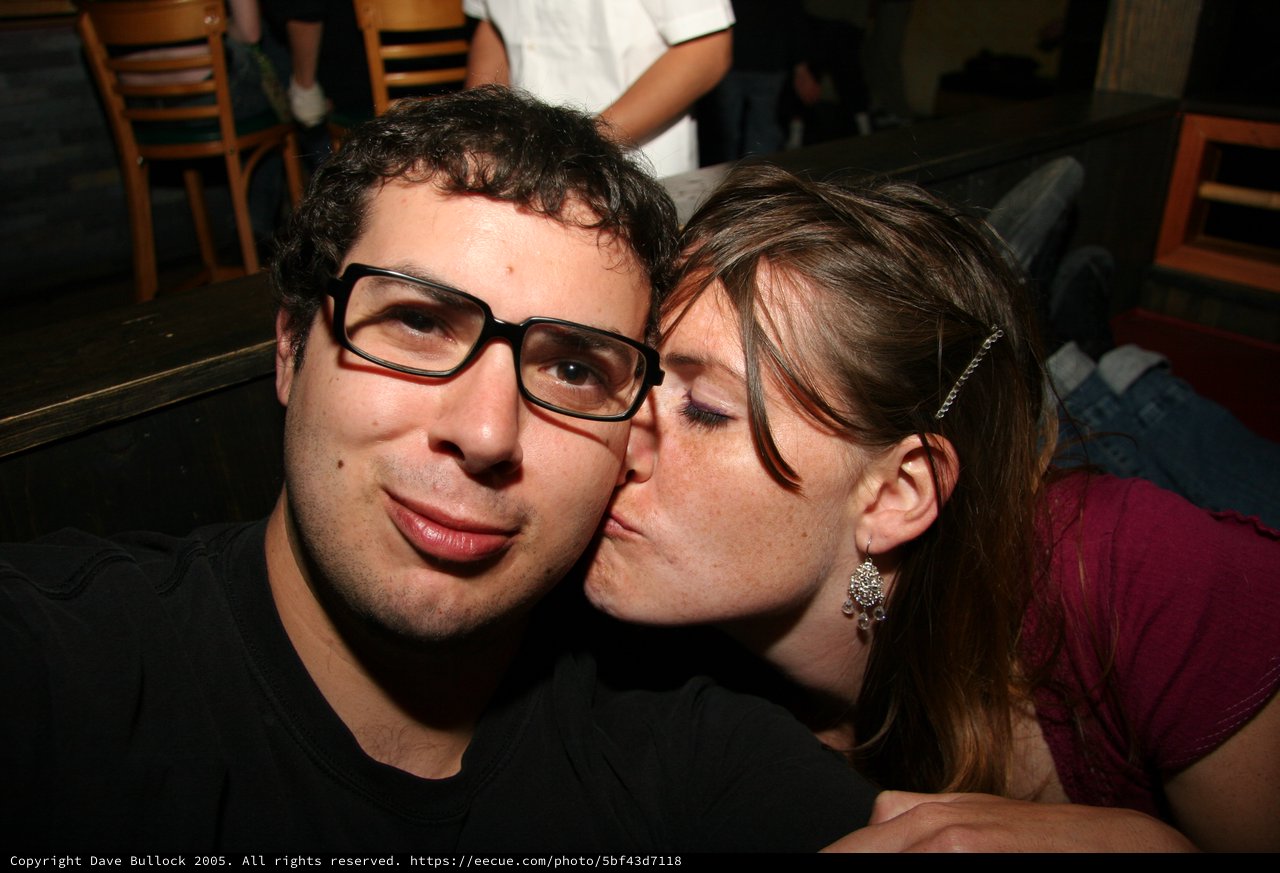 Spontaneous Kiss on the Cheek at a Bar