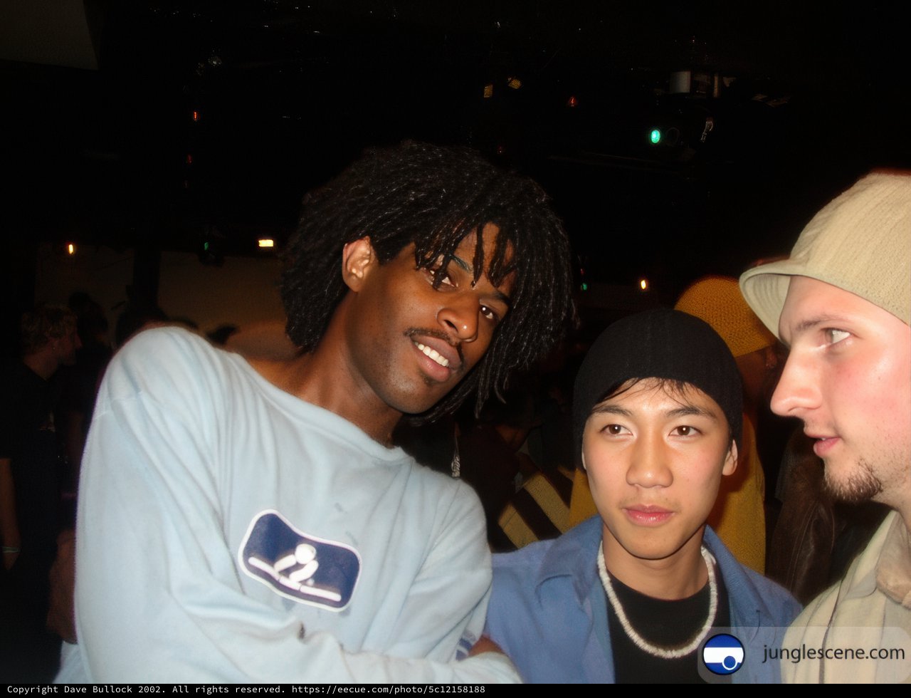 Three Men Posed in Hats at a Party
