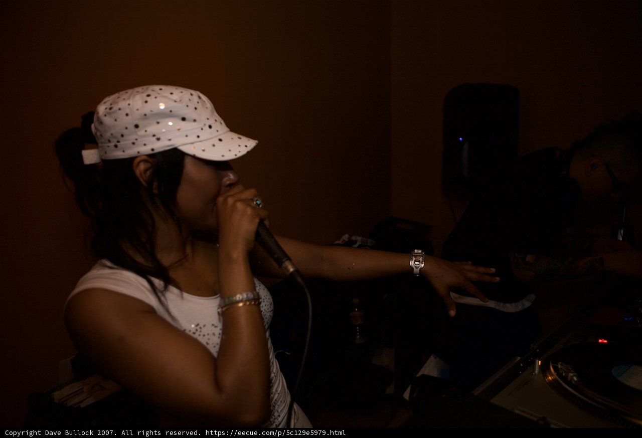Hat-wearing Woman DJs the Night Away
