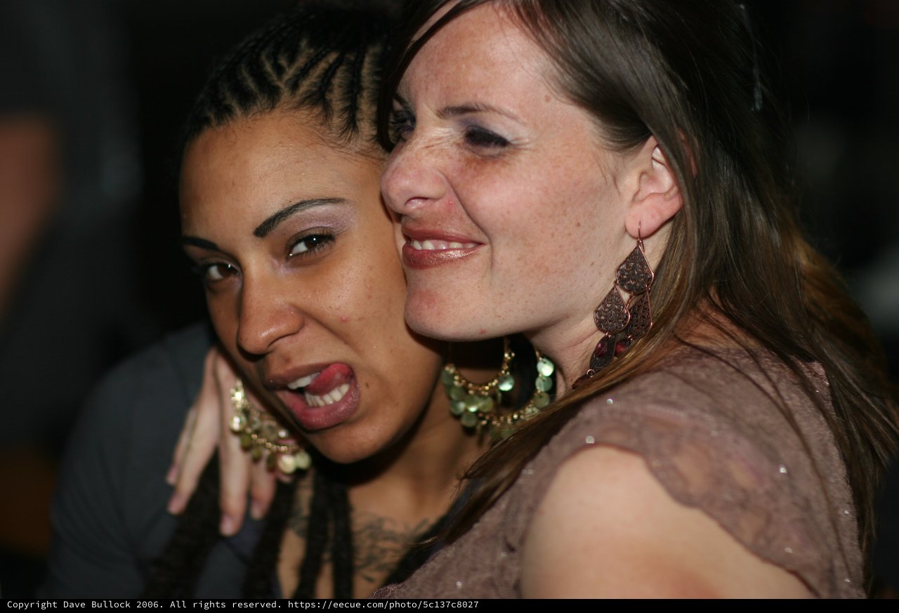 Two Friends Sharing a Joyful Moment at Nightclub