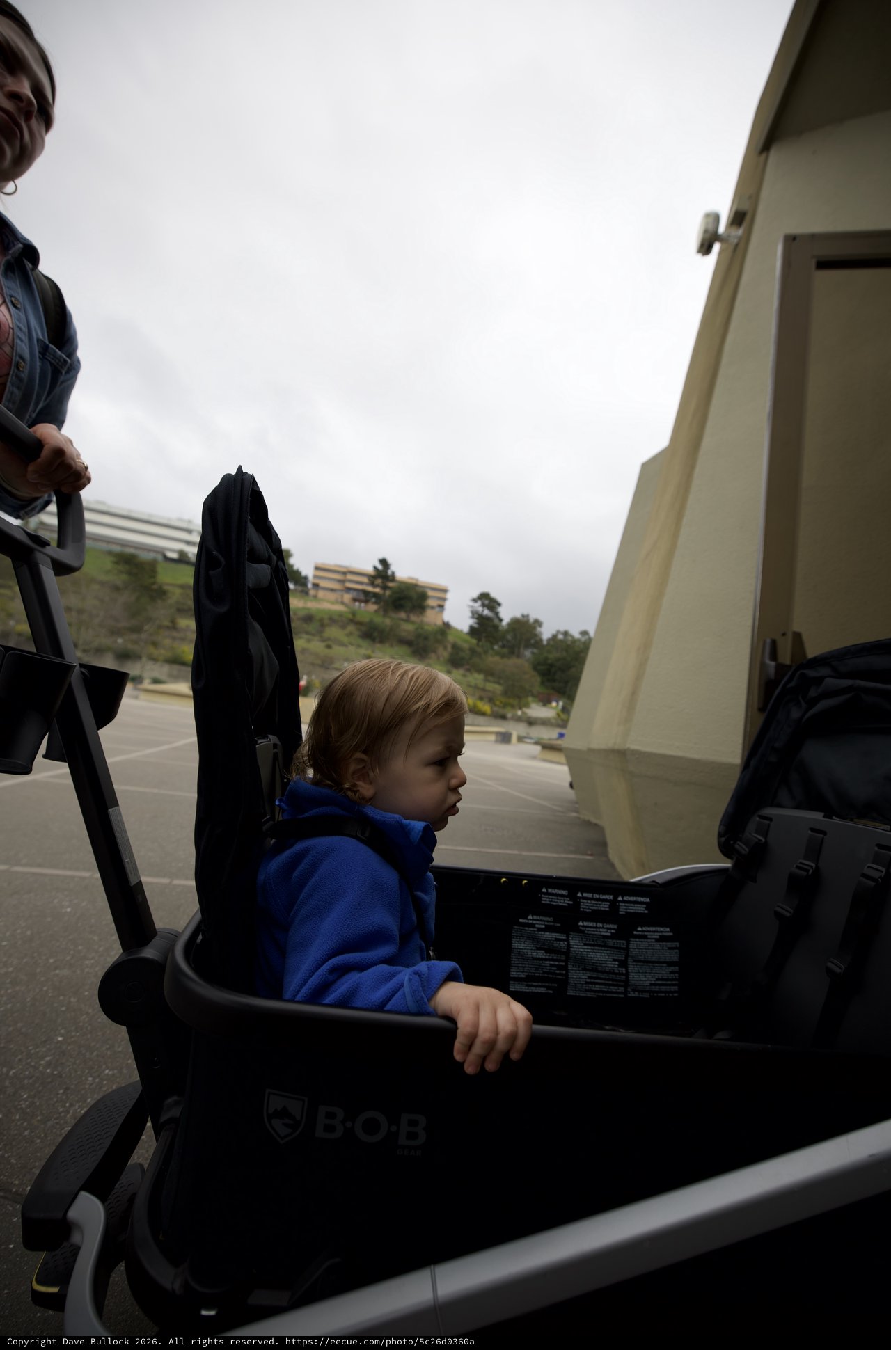 Young Child in Blue Hoodie Sitting in BOB Stroller