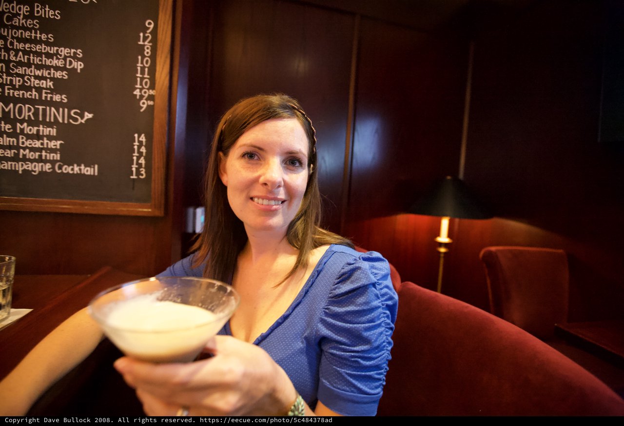 Woman Toasting with Creamy Martini at Upscale Bar