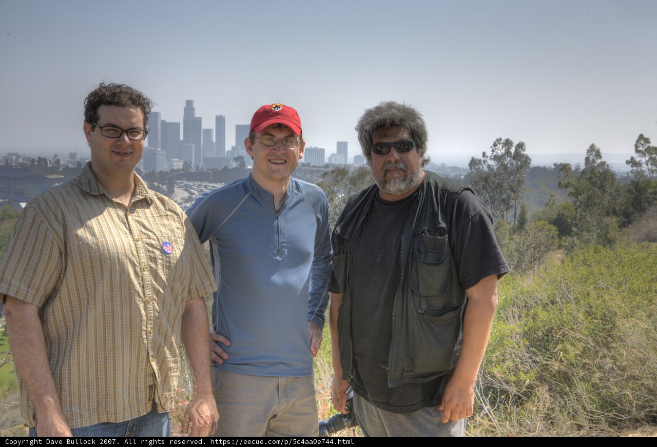 Three Men Enjoying a Sunny Day Outdoors
