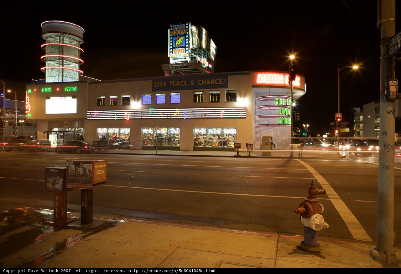 Neon Sign Lights Up the Night Sky in Urban Metropolis