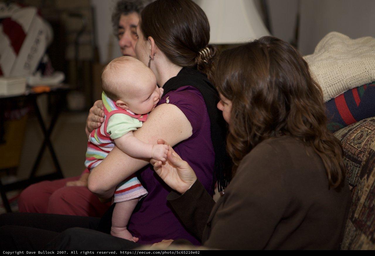 Tender Moment as Baby Nuzzles Into Mother's Shoulder