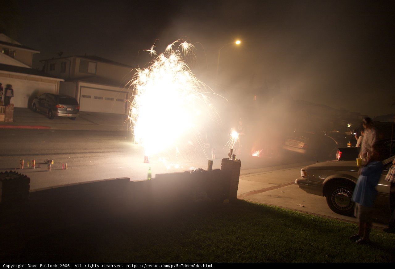 Fireworks light up the night sky over the city street