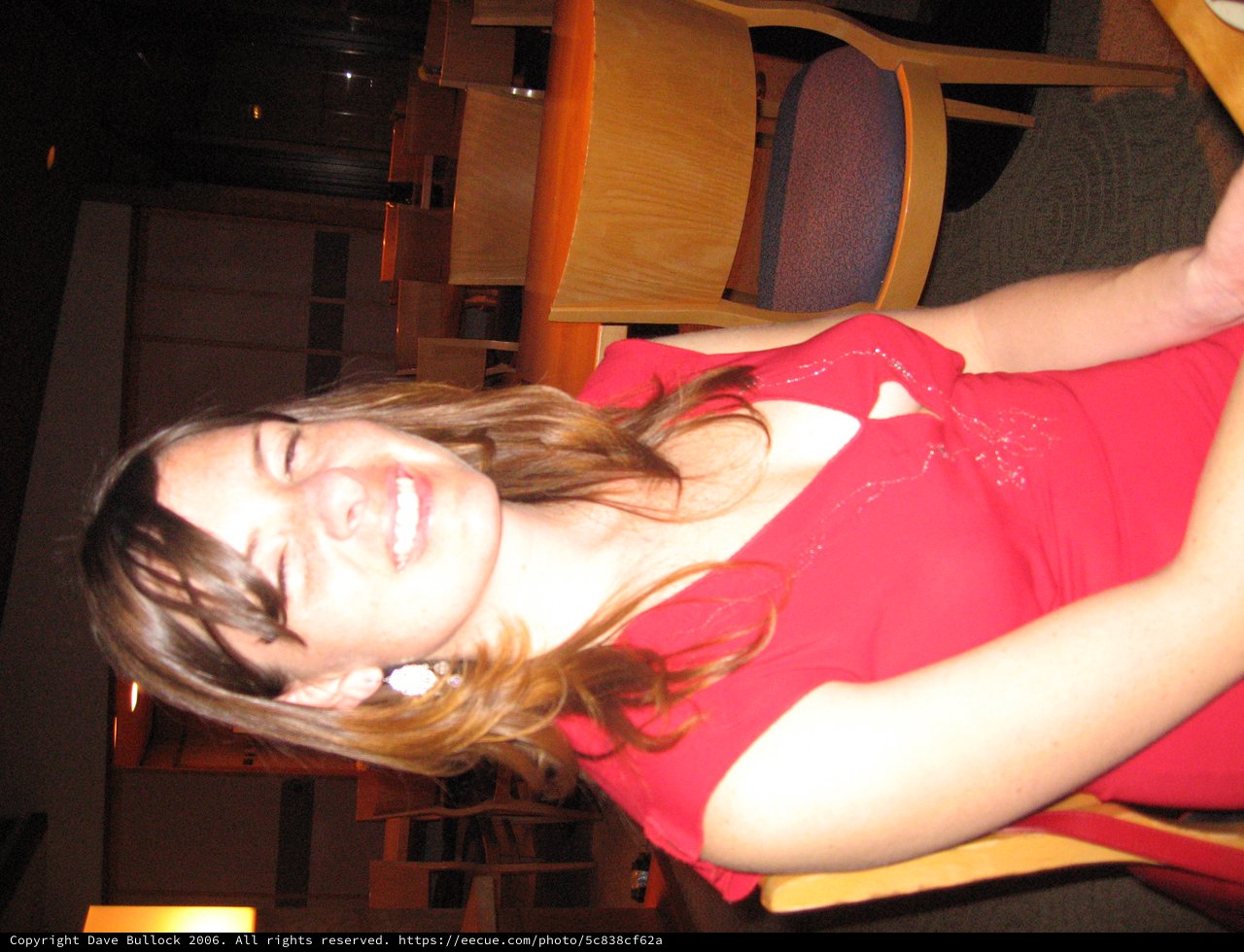 Laughing Woman in Red Dress at Evening Event