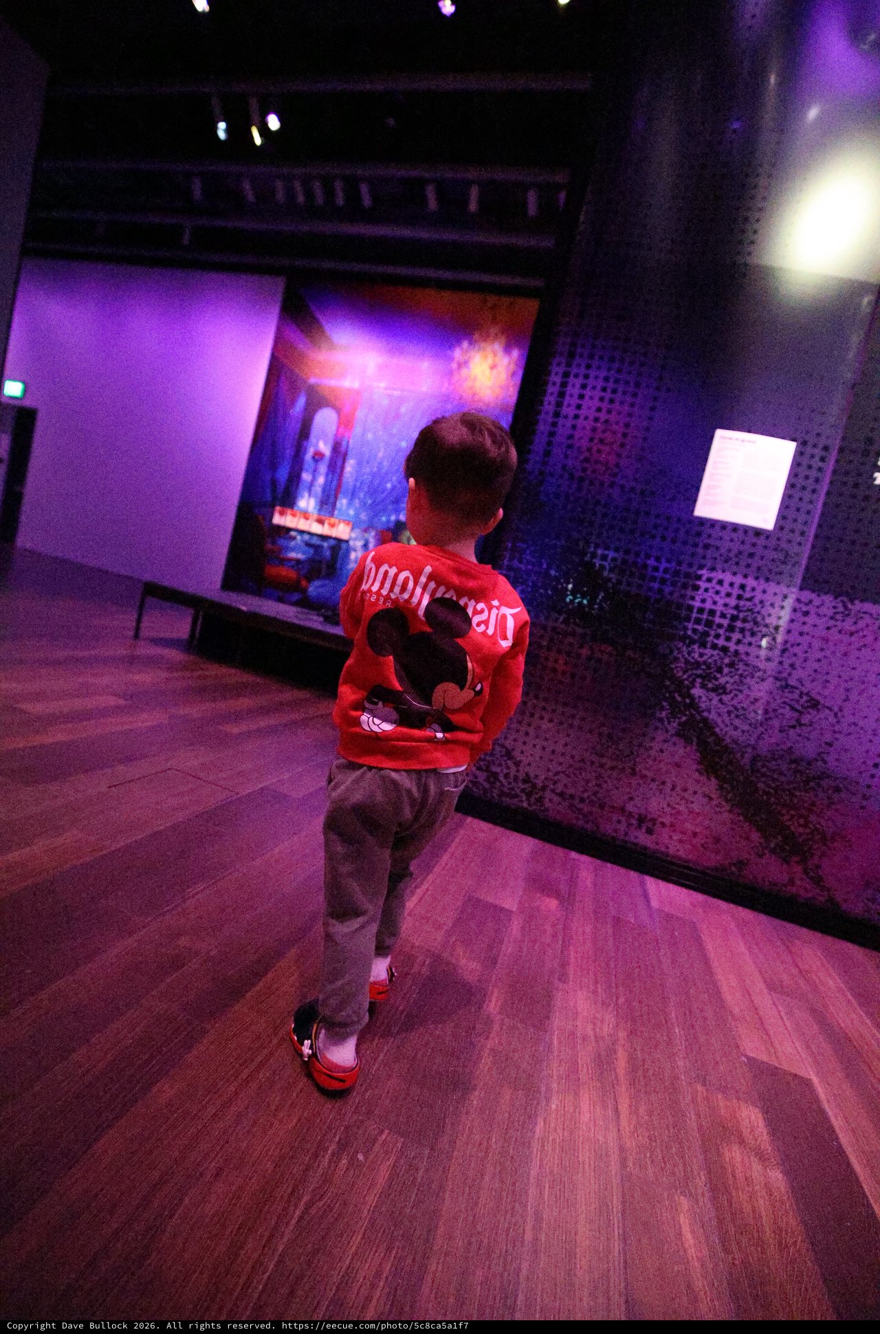 Child in Red Jacket at Baby Rave Museum Event