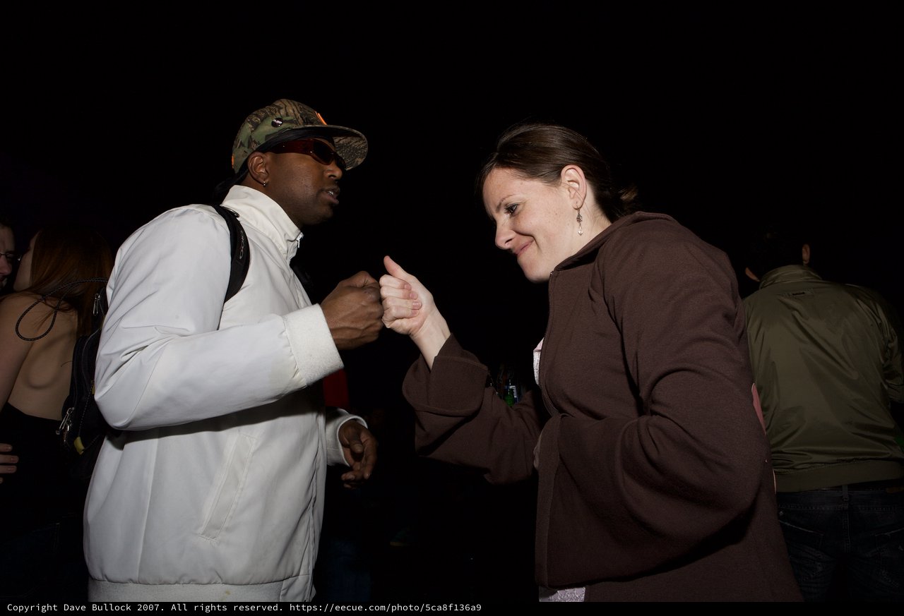 Fist Bump Connection at Night Outdoor Event