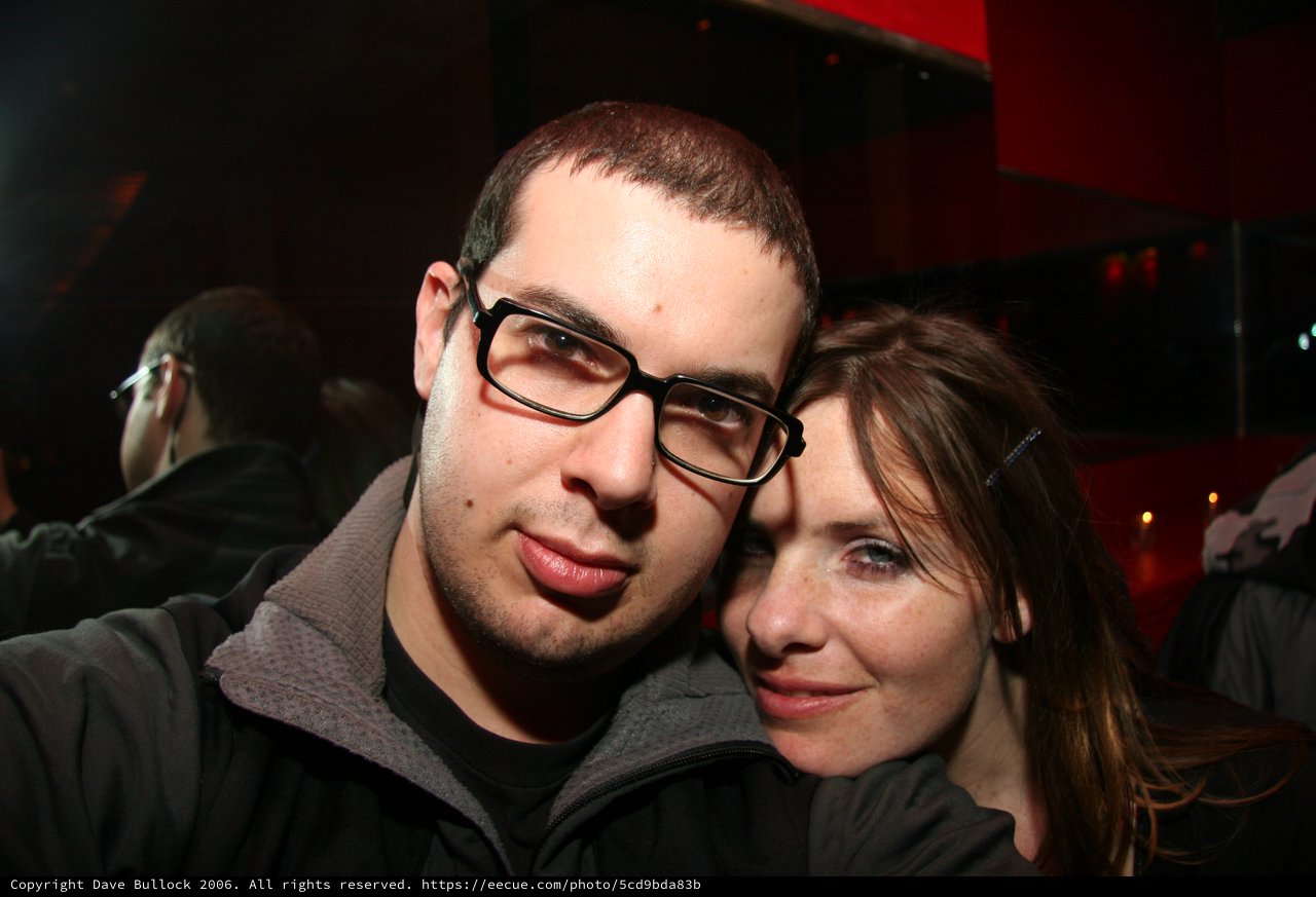Couple Poses Close Together at Nightclub Event
