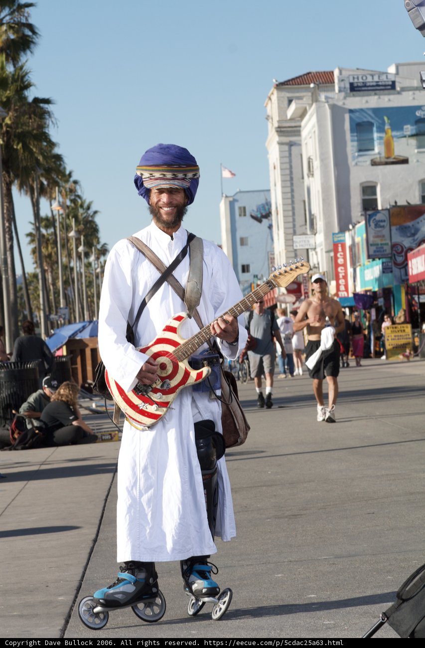 Guitarist playing under a bright blue sky