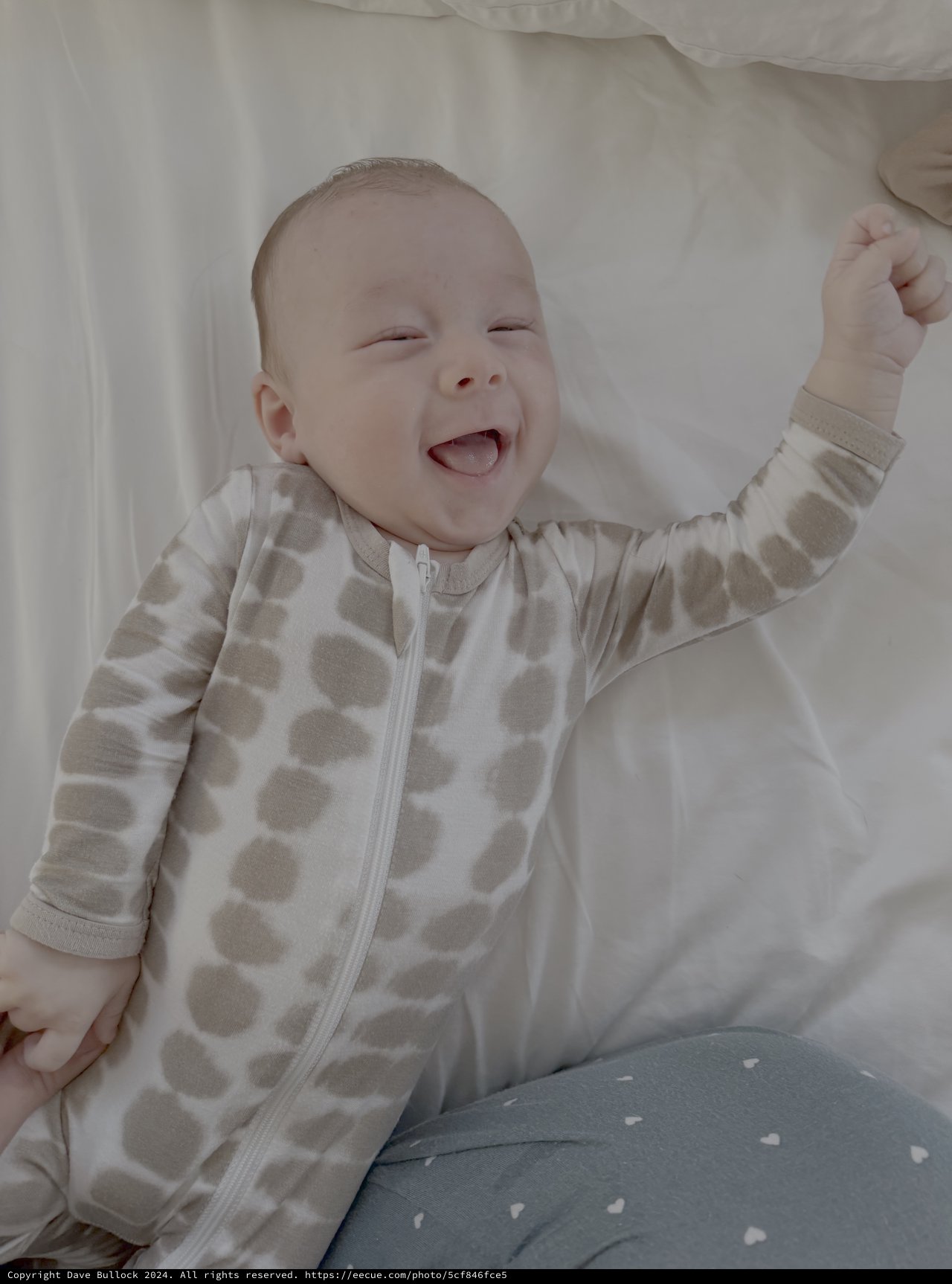Joyful Baby Laughing in Polka Dot Sleepwear