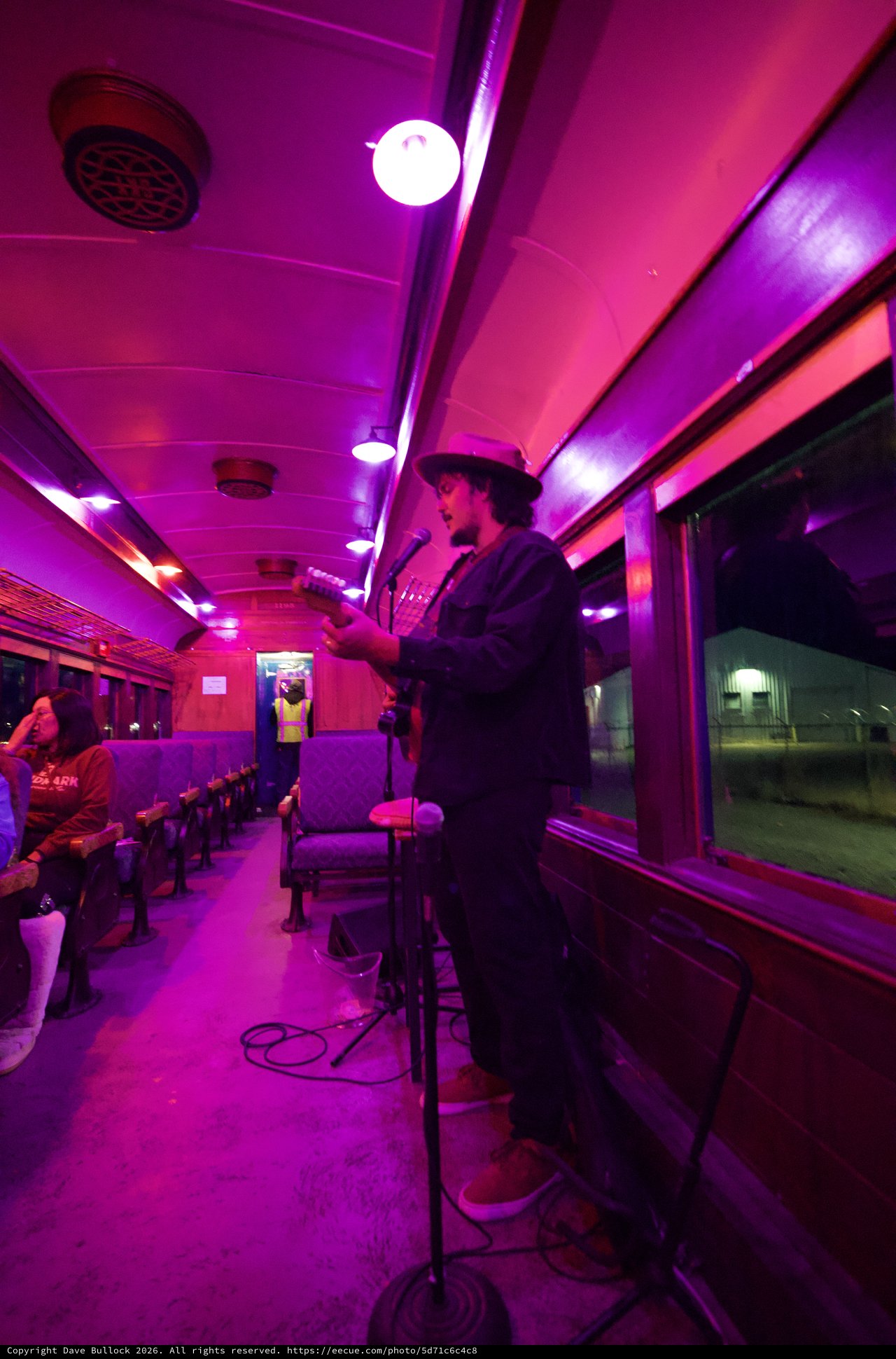 Live Music Performance in Vintage Purple-Lit Train Car