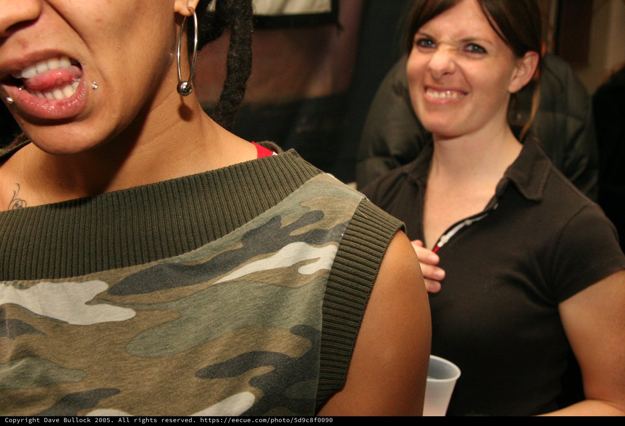 Two Women Laughing at a Casual Indoor Party