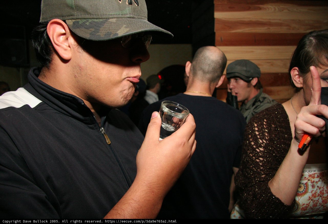 Man in Black Jacket with Baseball Cap and Sunglasses