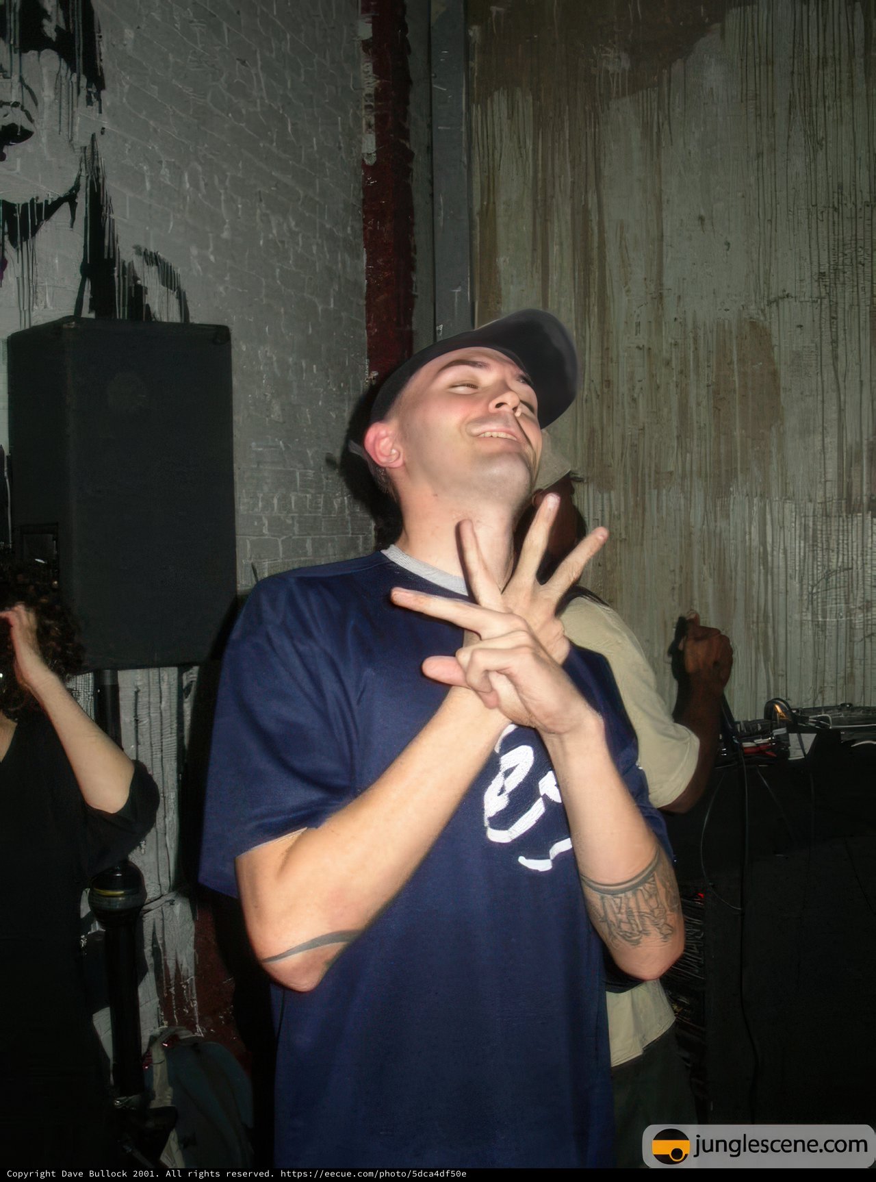 Tattooed Entertainer Gesturing with Style